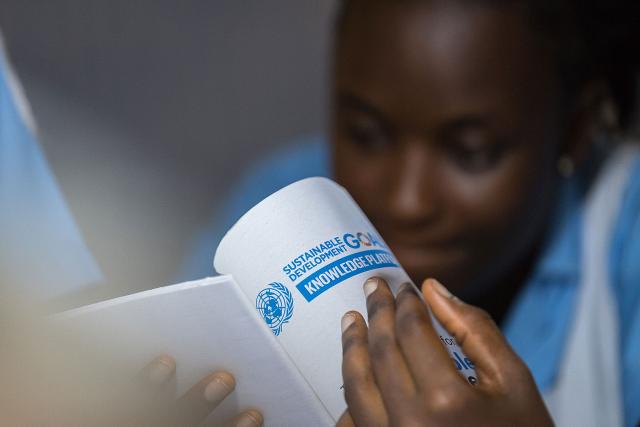 A female nurse at Ganta United Methodist Hospital reads about the SDGs.