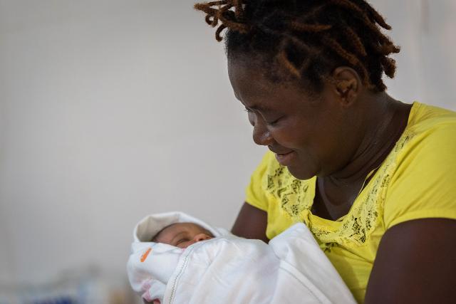 Rachel Zackpah from Ganta holds her two-day-old child in her arms.